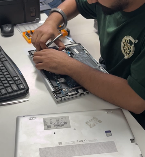 Technician repairing a laptop
